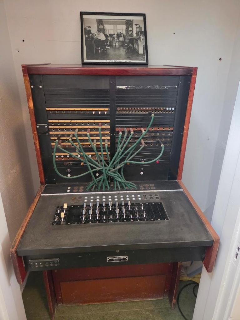 Original fire department dispatch PBX switchboard station with patch cables and toggle switches, used before computerized dispatch — first operated by firefighters then civilian dispatchers