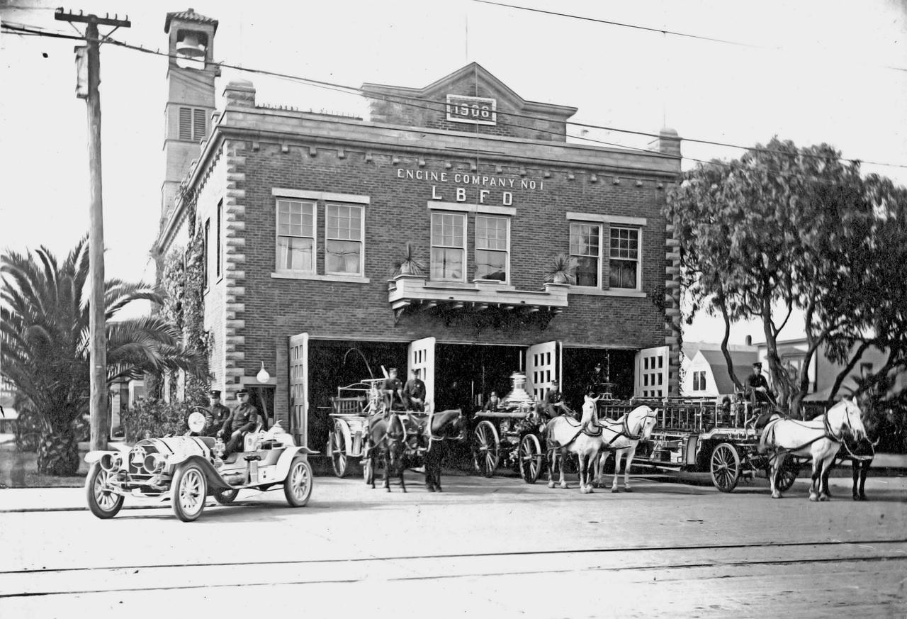 Historical photograph of Long Beach Fire Department Engine Company No. 1 in 1906, showing horses, steam engine, hose wagon, and ladder wagon outside the brick firehouse